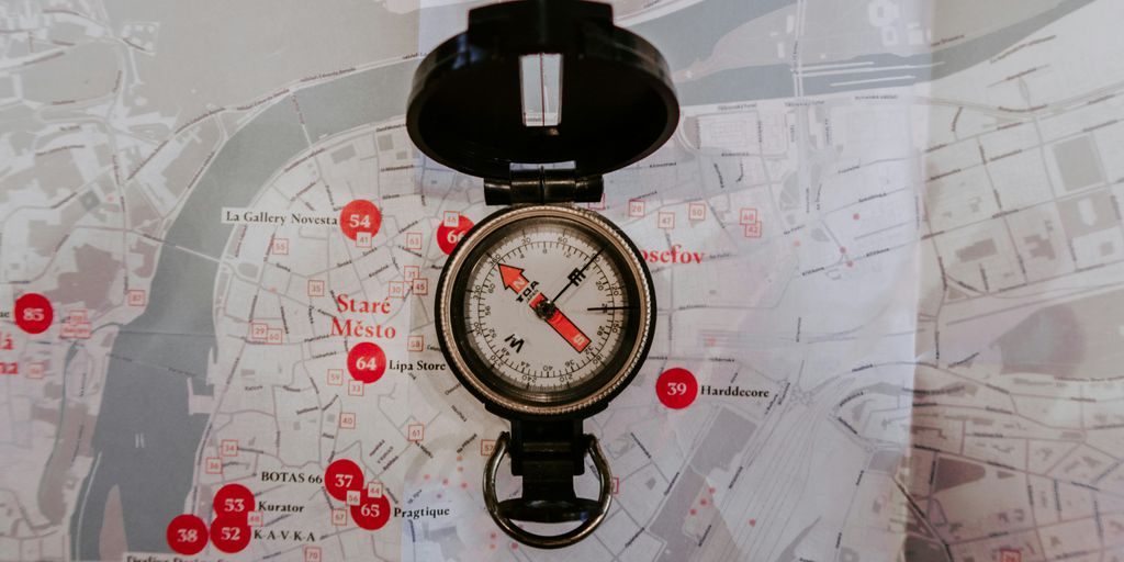 round black metal compass on map