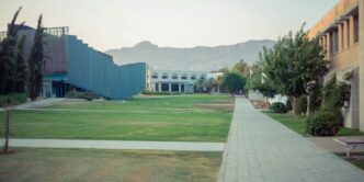 a courtyard with a building and trees