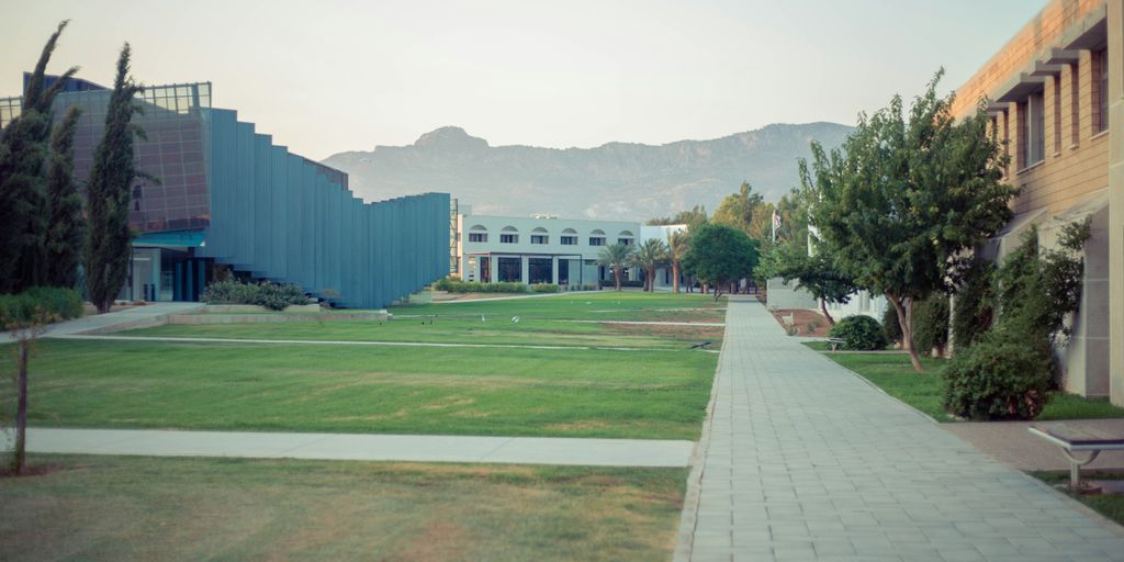 a courtyard with a building and trees