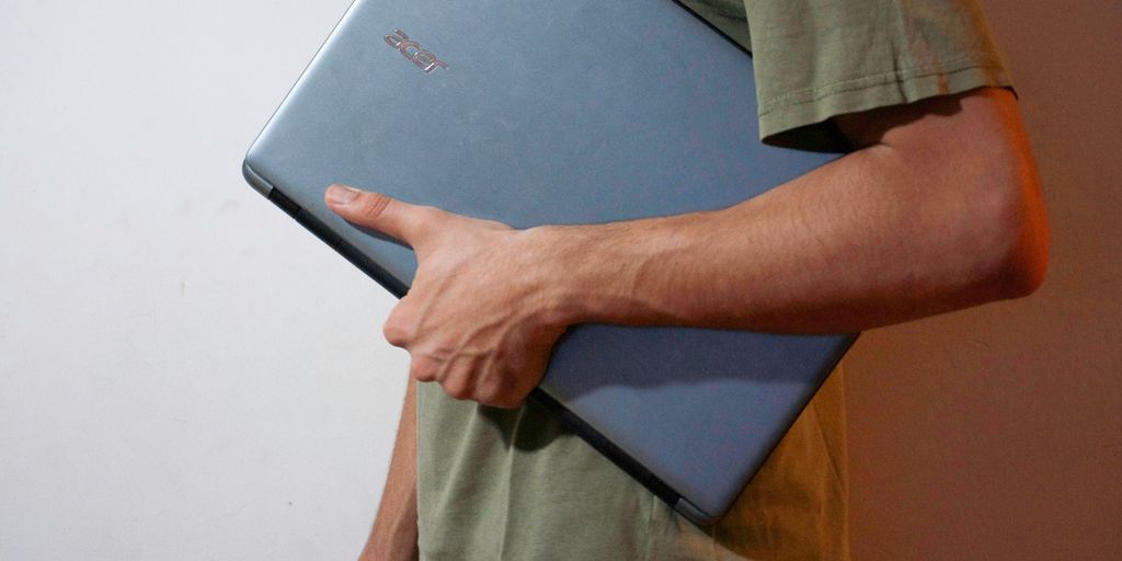 man in green button up shirt holding black tablet computer
