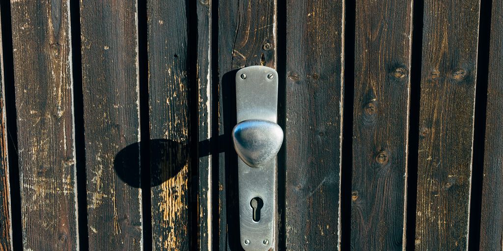 a metal door handle on a wooden door