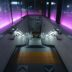 A train station with purple lights on the walls