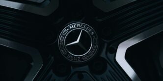 A mercedes-benz emblem is on a wheel.