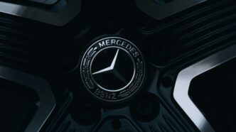 A mercedes-benz emblem is on a wheel.