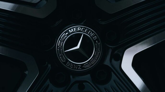 A mercedes-benz emblem is on a wheel.