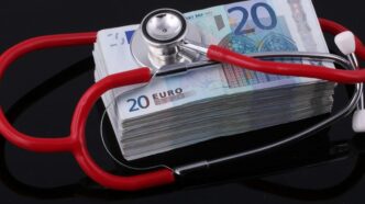 a stethoscope on top of a pile of euro bills