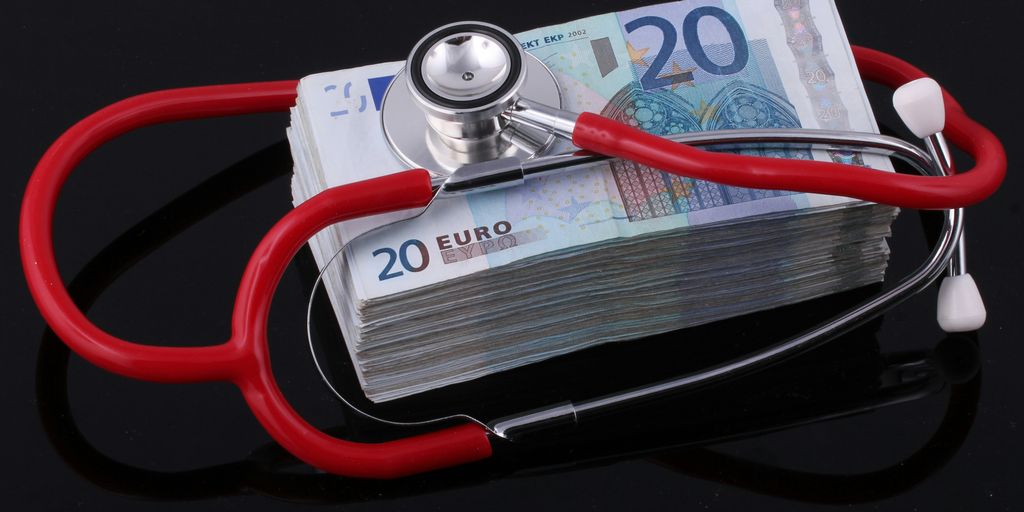 a stethoscope on top of a pile of euro bills