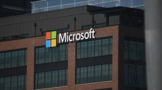 A tall building with a microsoft logo on top of it