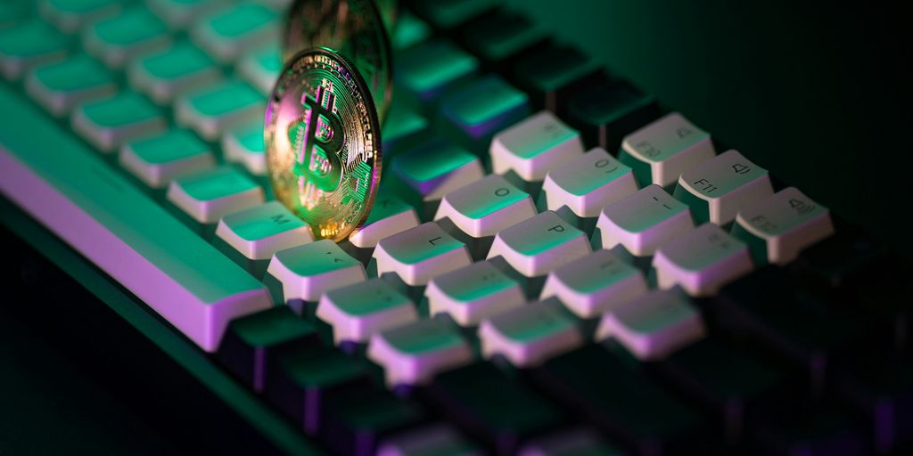 A close up of a computer keyboard with a light on it