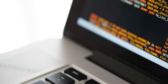 silver laptop computer on white surface