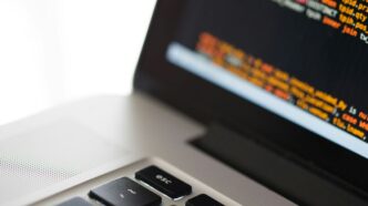 silver laptop computer on white surface