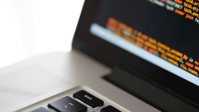 silver laptop computer on white surface