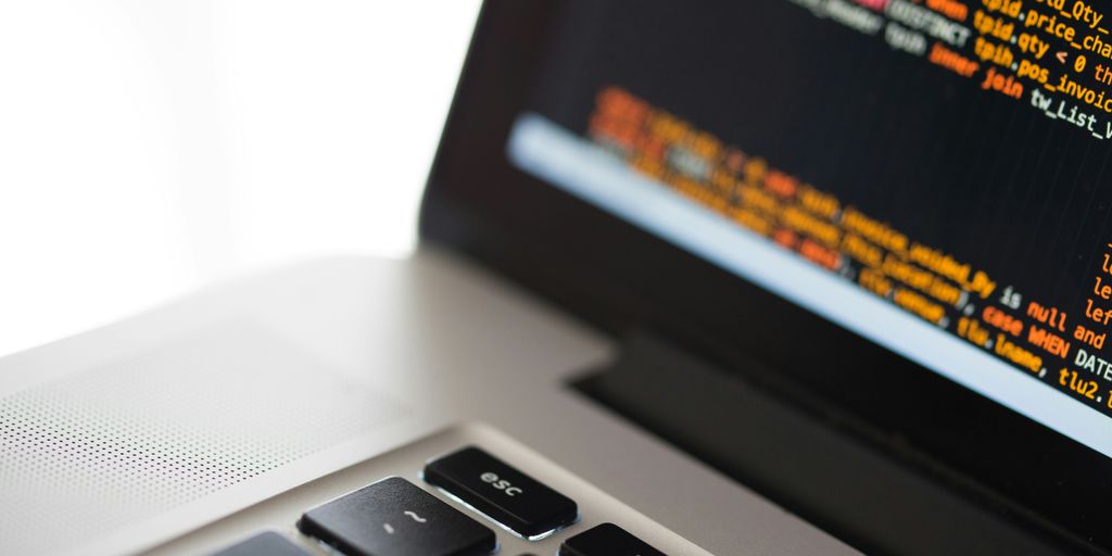 silver laptop computer on white surface