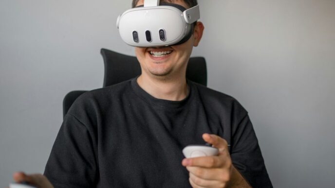 a man sitting in a chair holding a remote control