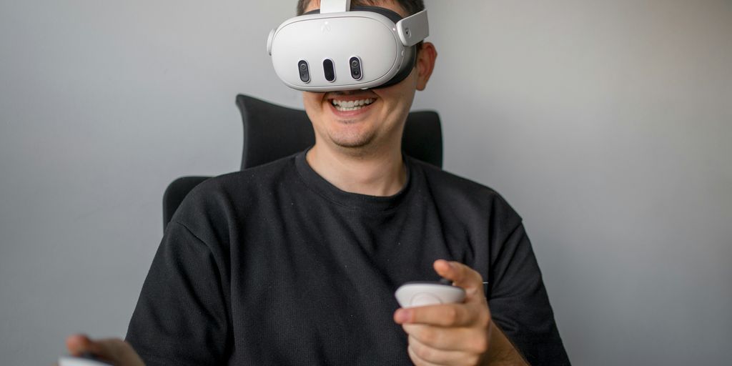 a man sitting in a chair holding a remote control