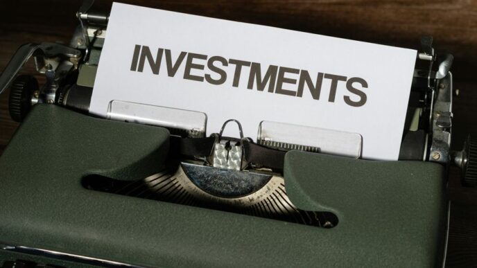 a close up of a typewriter with a paper that reads investments