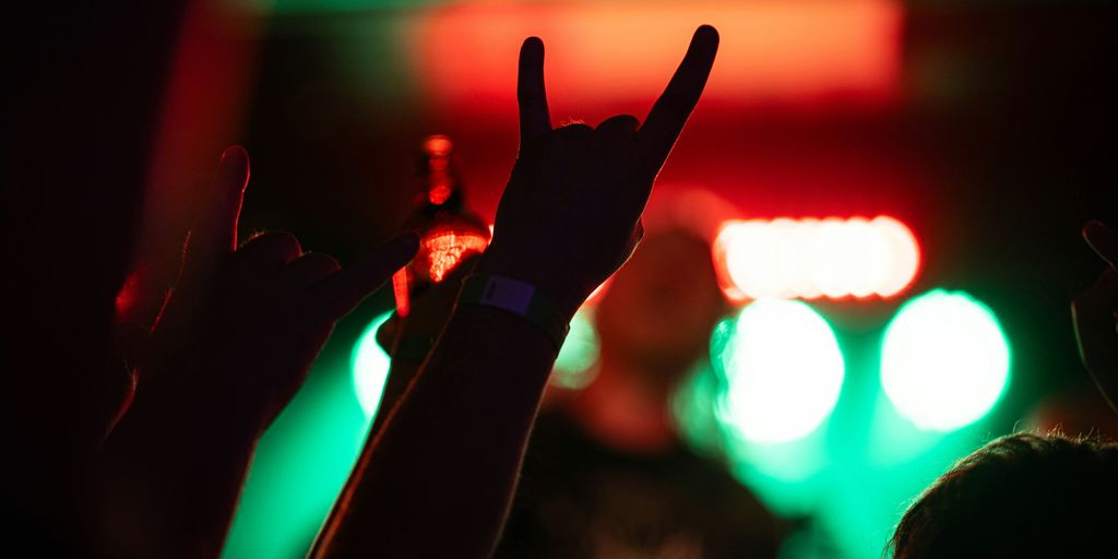 a group of people raising their hands in the air