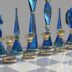 a chess board with blue glass pieces on it