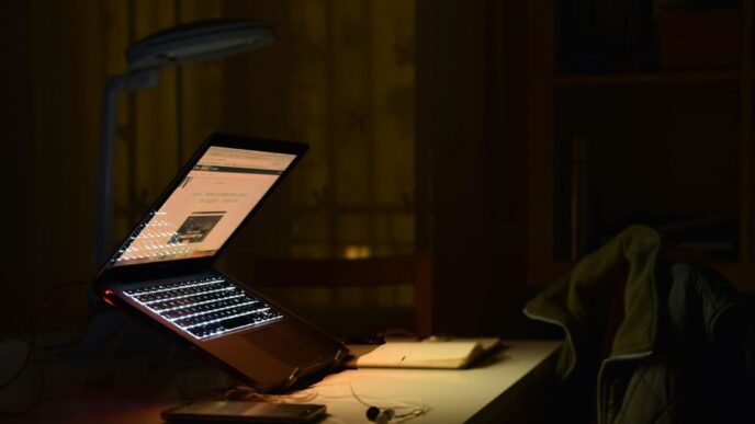 gray laptop computer turned on while in tilting position