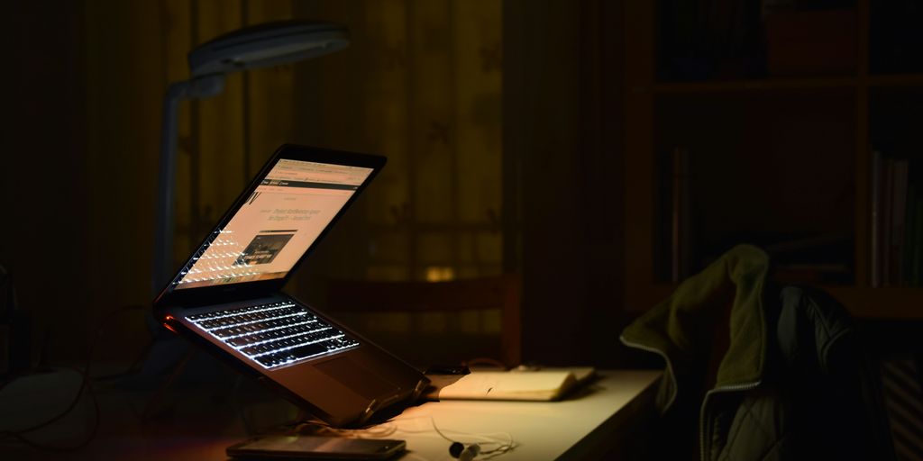 gray laptop computer turned on while in tilting position