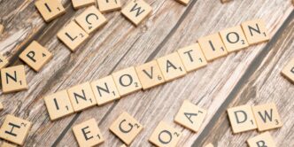 scrabble tiles spelling the word innovation on a wooden surface