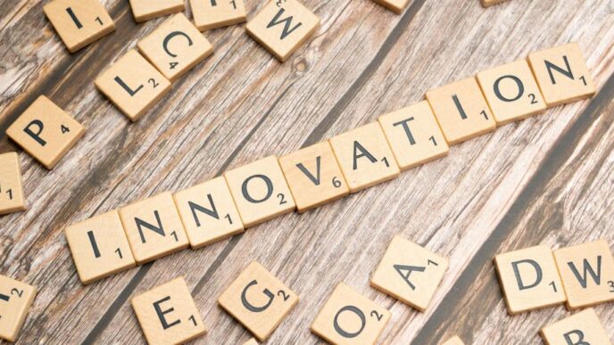 scrabble tiles spelling the word innovation on a wooden surface
