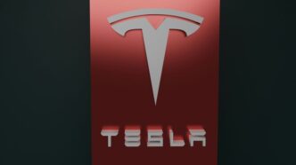 a red tesla logo on a black background