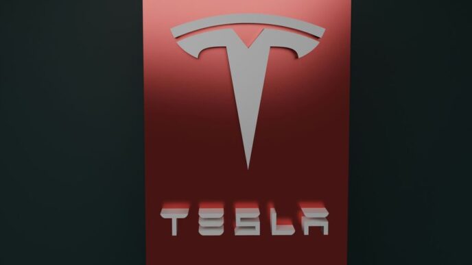 a red tesla logo on a black background