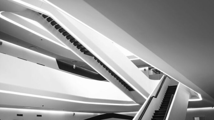 a black and white photo of an escalator