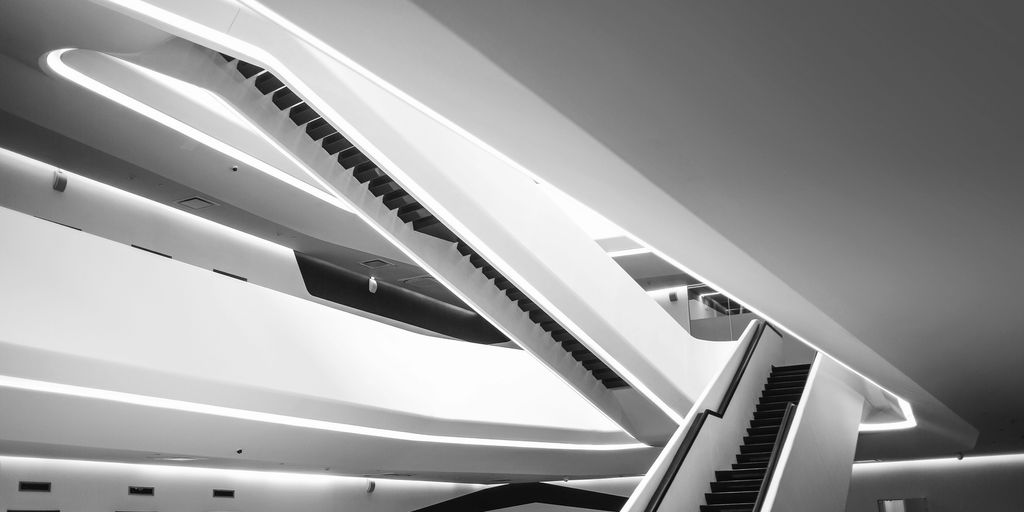 a black and white photo of an escalator