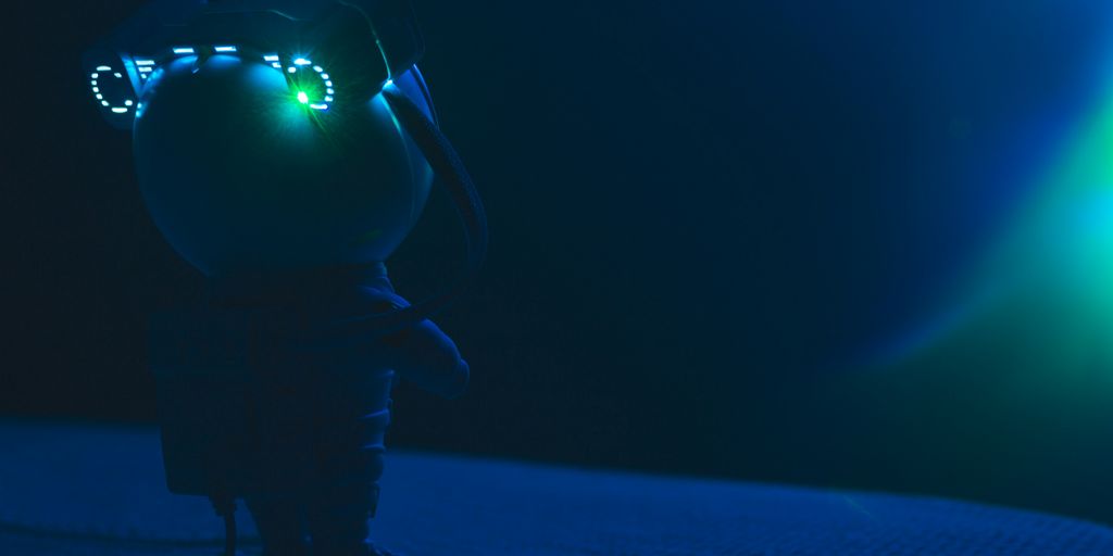 a stuffed animal with glowing eyes on a bed