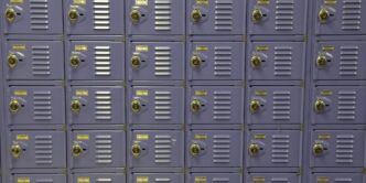 a wall of purple lockers with yellow tags on them