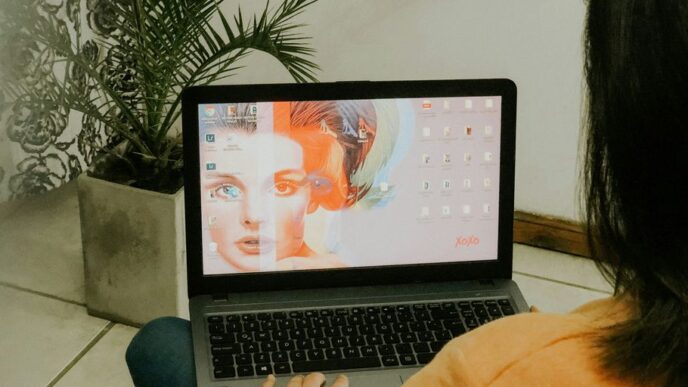 woman in yellow long sleeve shirt using macbook pro