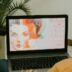 woman in yellow long sleeve shirt using macbook pro