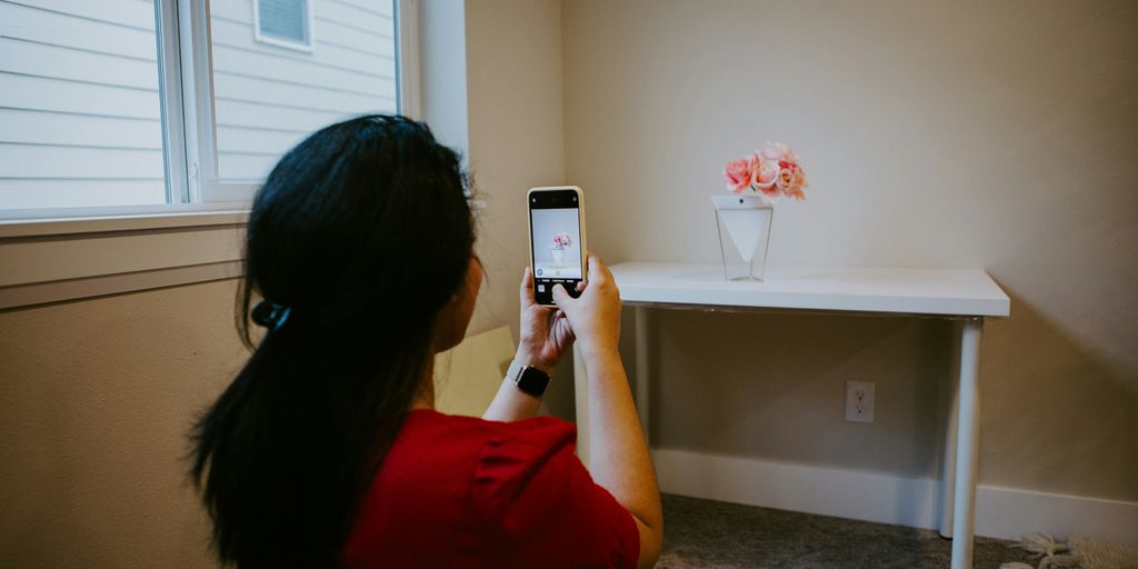 woman in red long sleeve shirt holding silver iphone 6