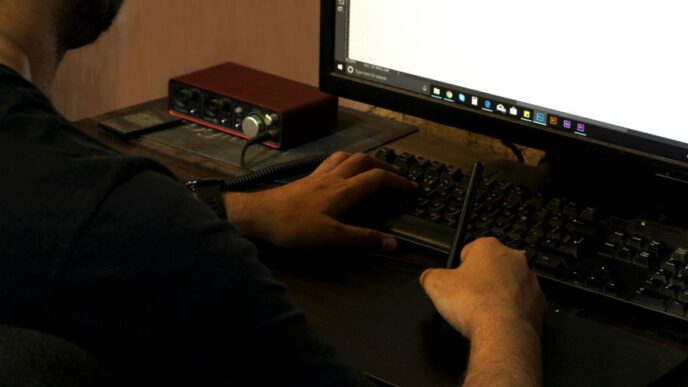 person in black long sleeve shirt using computer