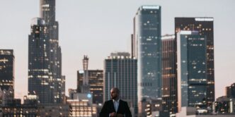 man in black jacket standing on top of building during daytime