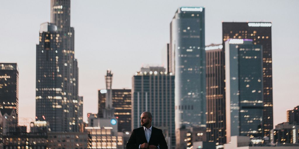 man in black jacket standing on top of building during daytime