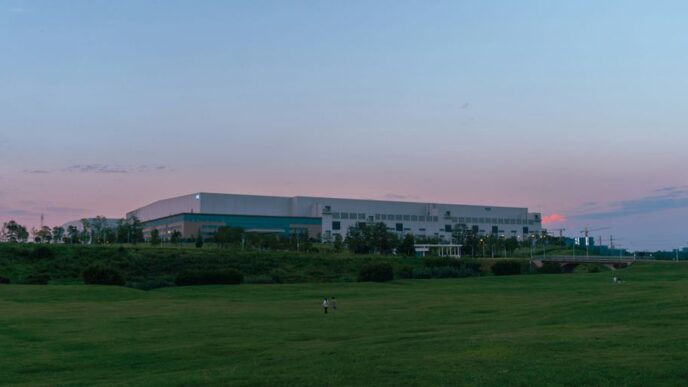 a large building sitting on top of a lush green field