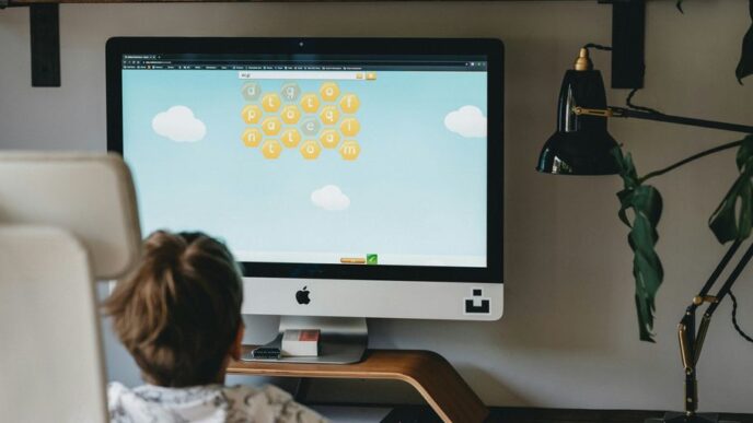 girl in white and blue floral shirt sitting on chair in front of silver imac