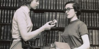 two women talking in the library