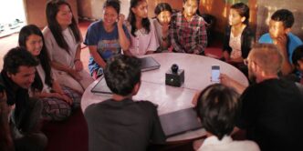 people sitting on floor front of table