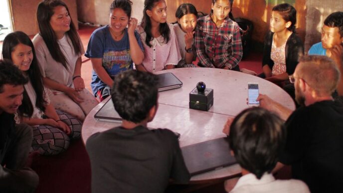 people sitting on floor front of table