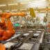 a factory filled with lots of orange machines