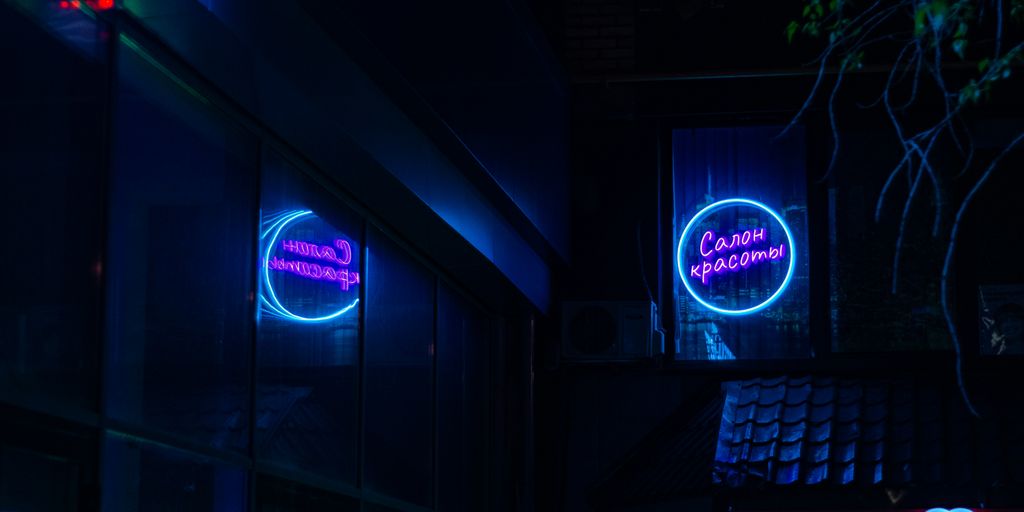 a building that has a neon sign on it