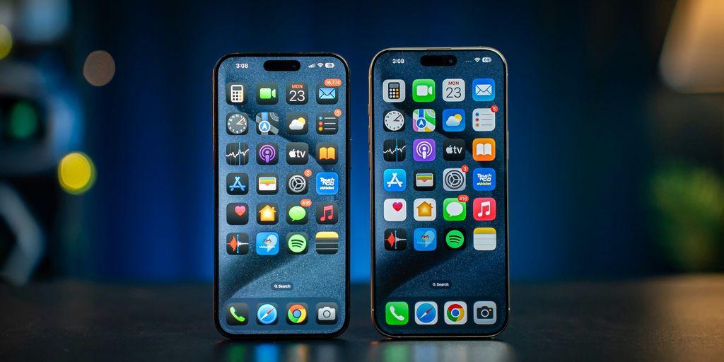 Two cell phones sitting next to each other on a table