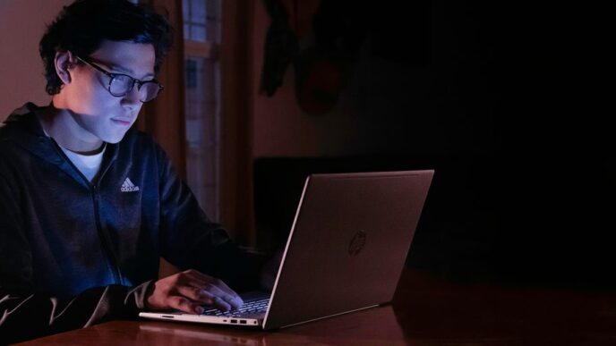 man in blue dress shirt using macbook