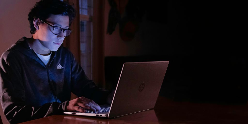 man in blue dress shirt using macbook