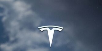A picture of a tesla logo on a car window