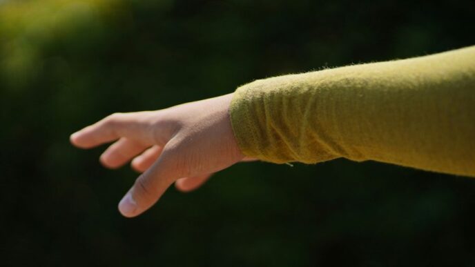 a person's hand reaching for something in the air